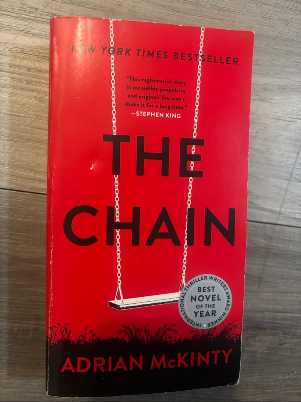 The Chain by Adrian McKinty - Red Paperback Thriller
